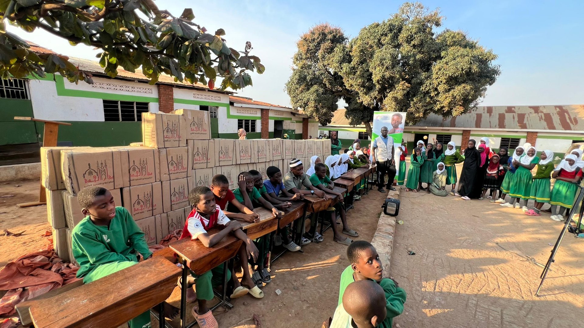 SODO outreach team addressing students seated at desks outside a school