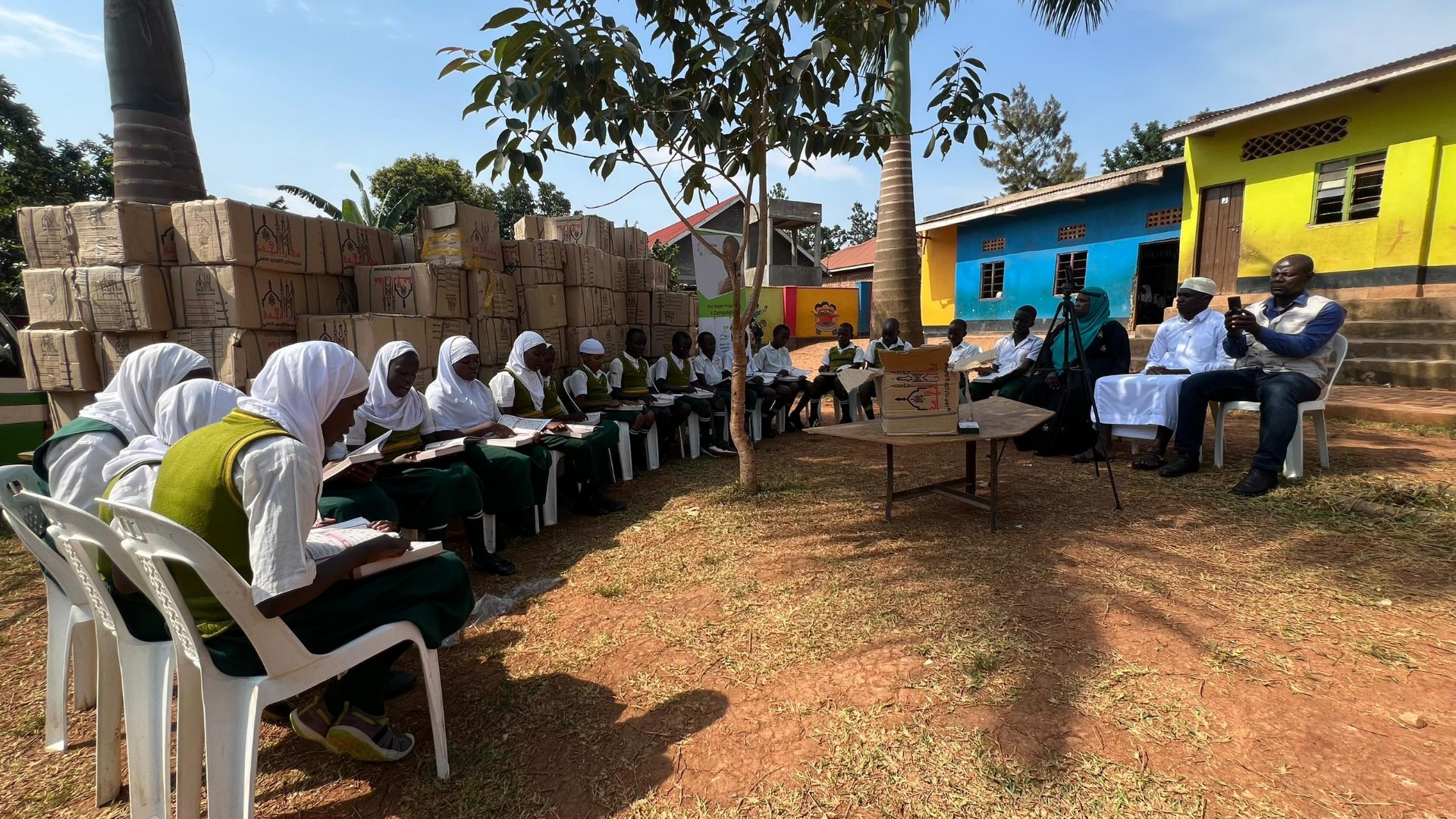Students reading Qur'ans in an outdoor SODO learning circle